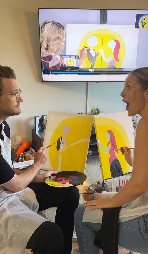 Couple painting the We're Simply Meant to Be date night diptych along to the video